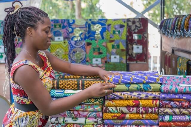 A lady selling African print clothing materials