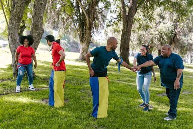 Families playing sack race in a park