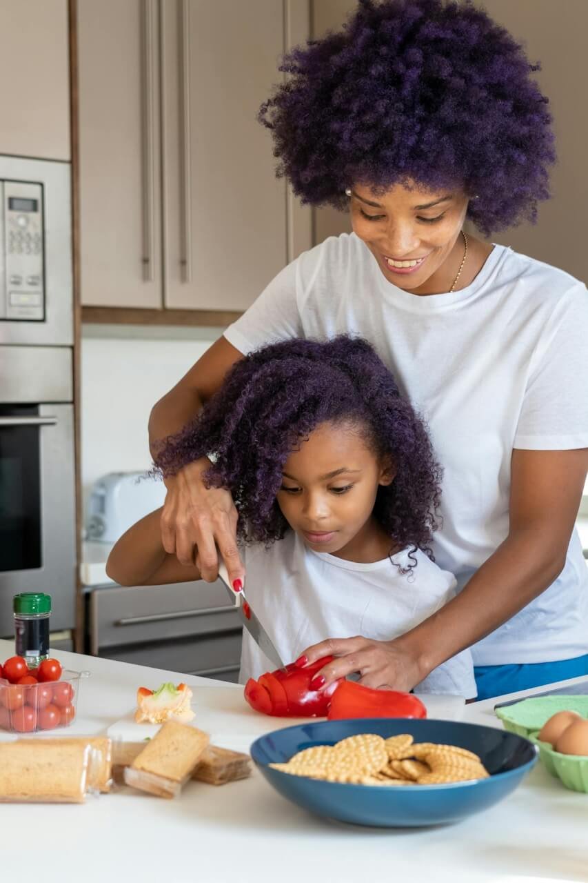 A mother and daughter cooking together