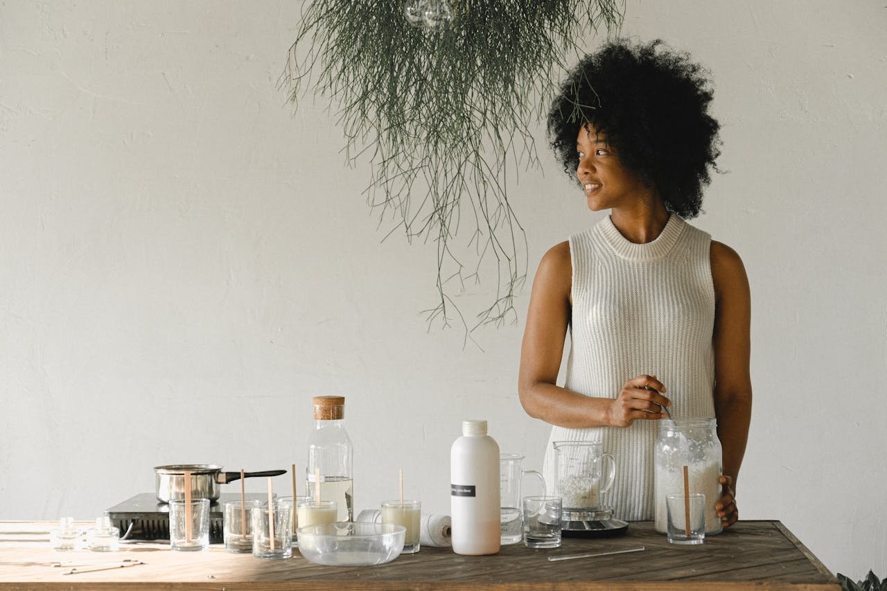 black-woman-at-table-with-ingredients-for-candle-making