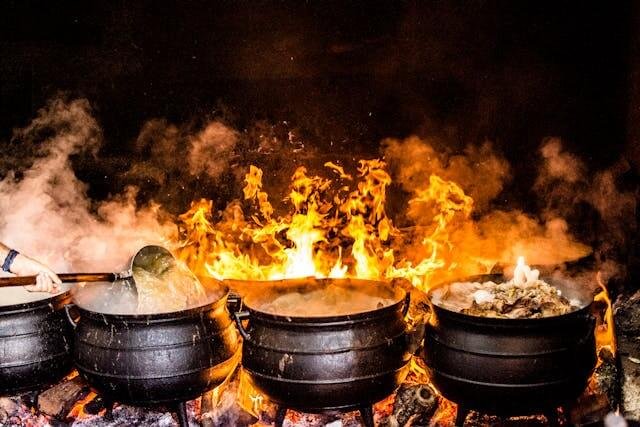 Four black metal cooking wares